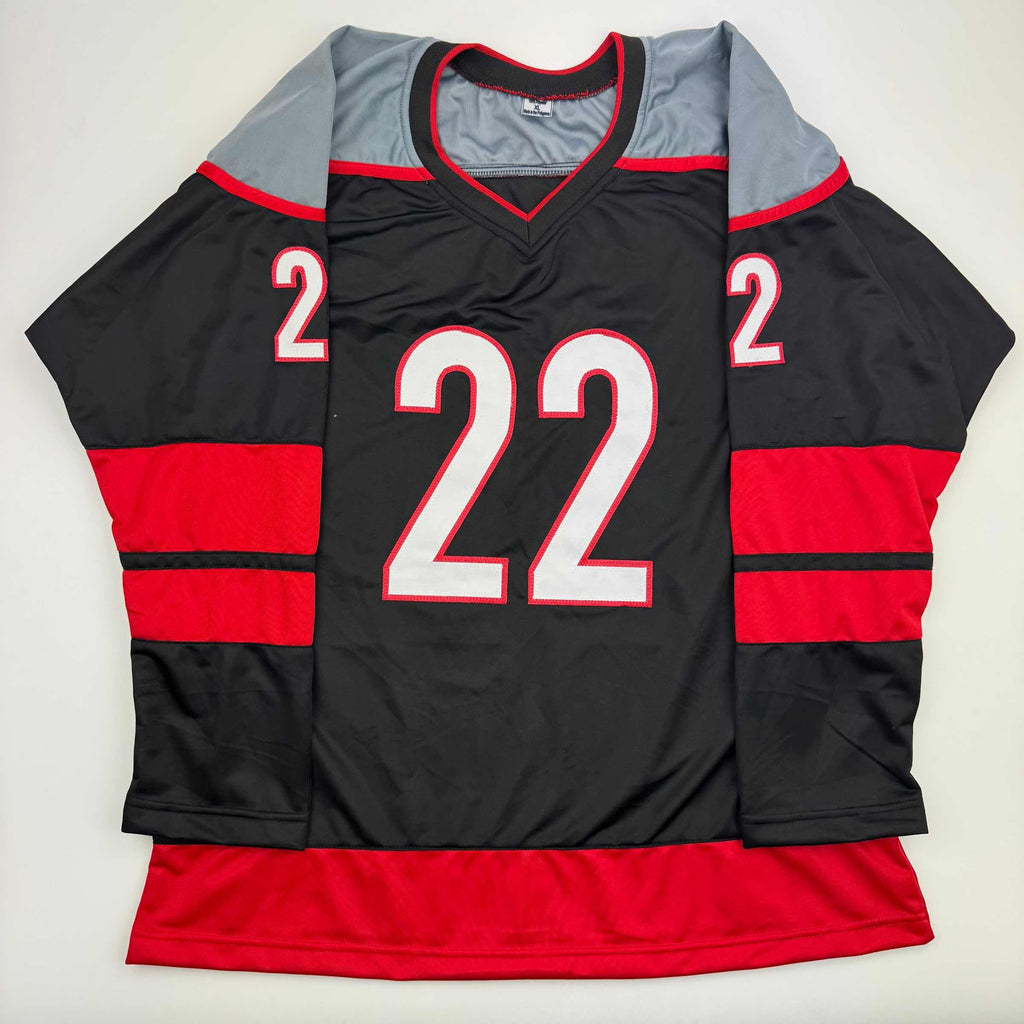 Autographed/Signed Logan Stankoven Carolina Black Hockey Jersey Beckett BAS COA