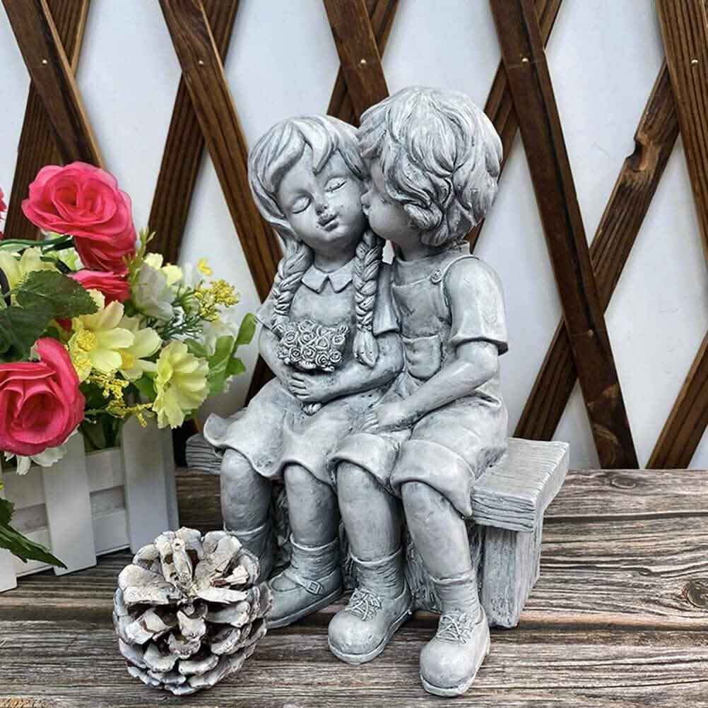 Boy Kissing Girl Statue Sitting on Bench Figurine